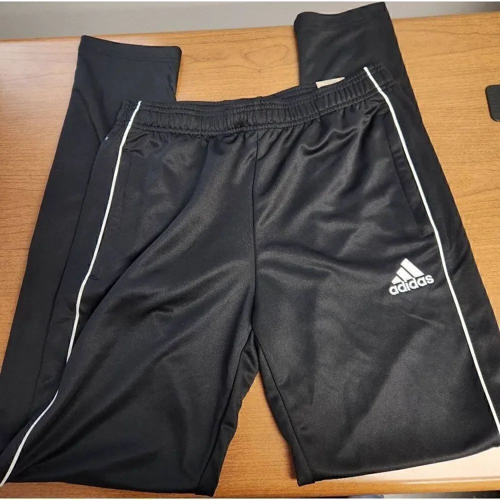 NWT Adidas Youth XL Black with white trim, Tapered fit pants. Has zippered pocke